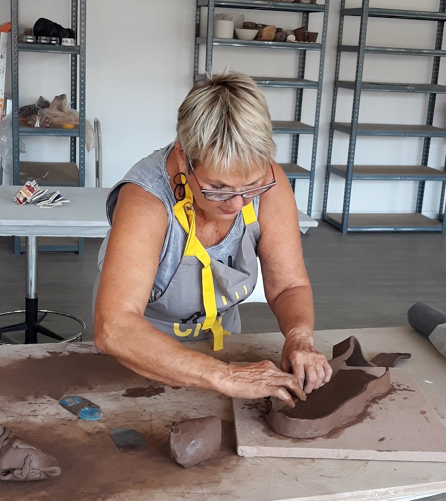 woman shaping clay with hands
